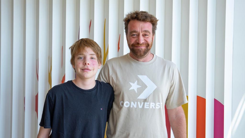 Manu, who underwent jaw and cheekbone reconstruction, with his father at the SJD Barcelona Children's Hospital