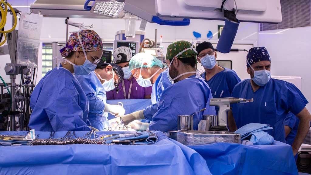 SJD surgical team during the operation on an infant with a double pathology SJD surgical team during the operation on an infant with a double pathology