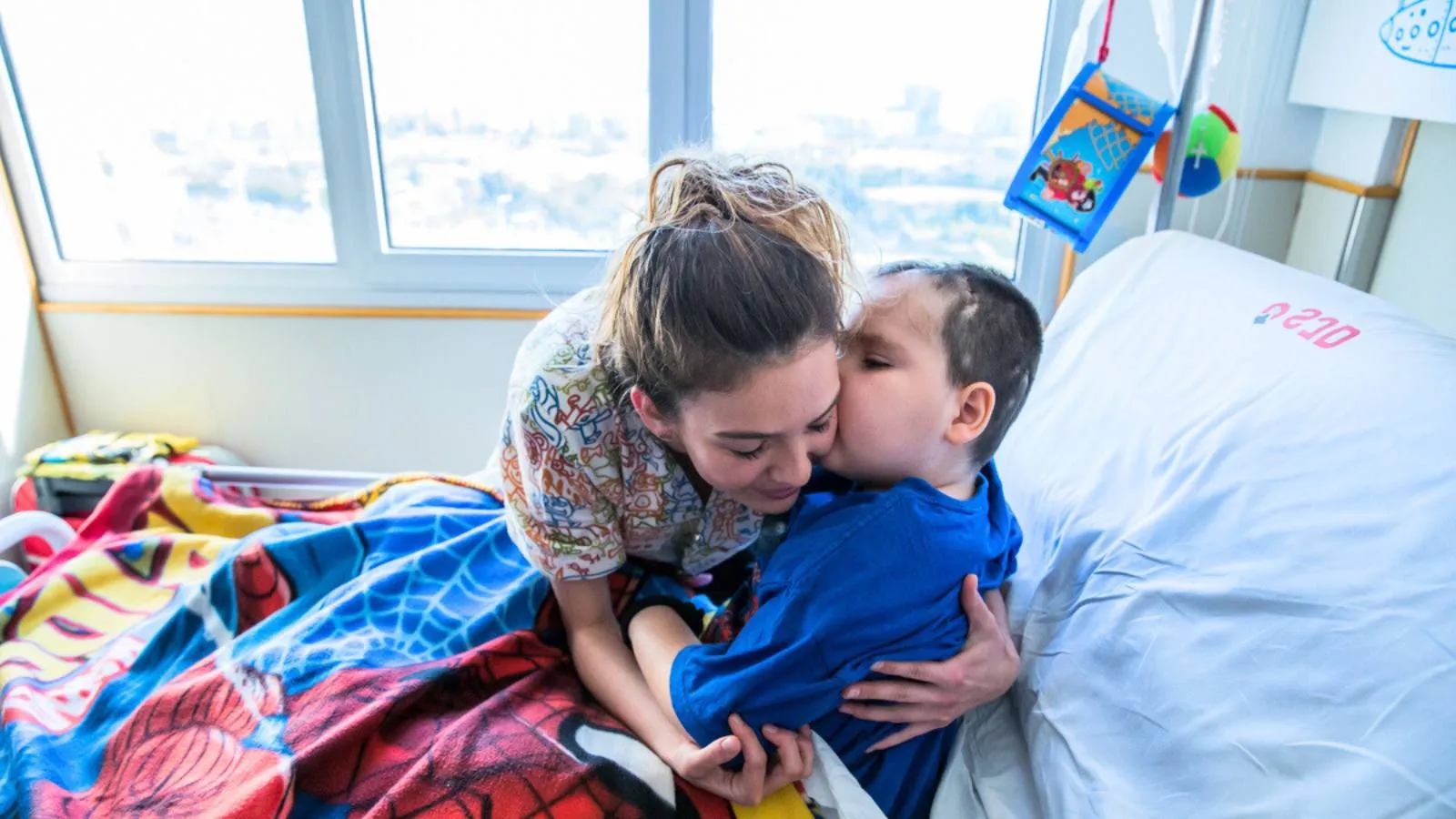 A patient of the SJD Barcelona Children's Hospital kisses the nurse who attends him A patient of the SJD Barcelona Children's Hospital kisses the nurse who attends him