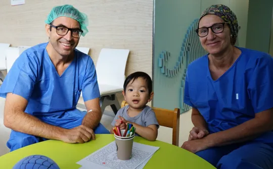 Retinoblastoma patient with pediatric ophthalmologist and nurse