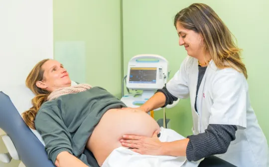 Midwife examines a pregnant patient