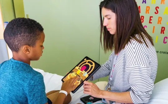 Sònia Tordera enseñando a un niño la aplicación Infukids