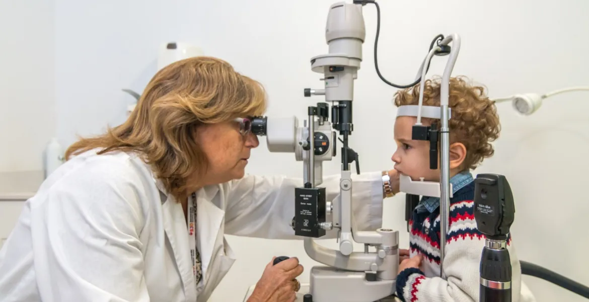 A patient and an ophthalmologist during a pediatric ophthalmology examination at the SJD Barcelona Children's Hospital Patient and doctor during ophthalmological examination