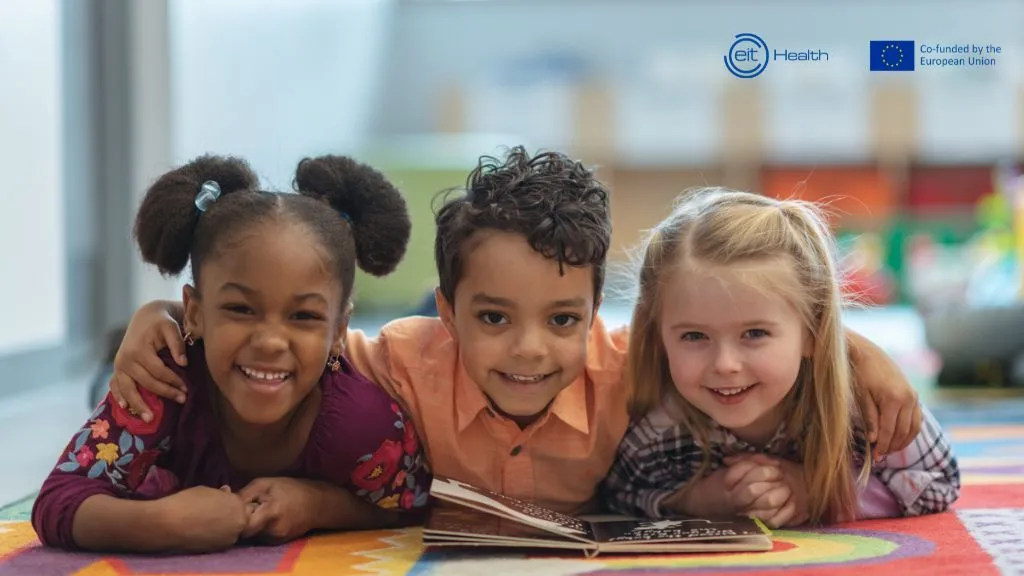 Promotional image of EIT Health's Wild Card program. Three children from different backgrounds smile at the camera