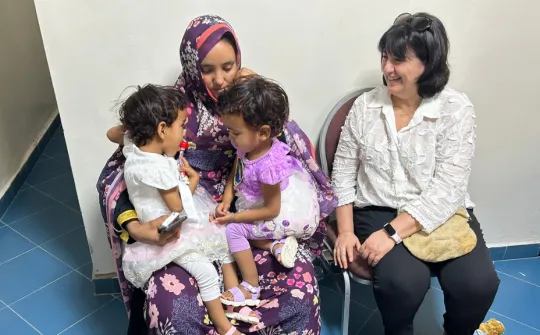 Nurse Patricia Romero on the right and the mother with the two girls on the left Visit from SJD Hospital professionals to Mauritania