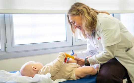 OTC gene therapy at Sant Joan de Déu Dr Àngels García with a baby in her office at Sant Joan de Déu Hospital