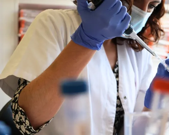 A professional processes a sample in the molecular diagnostic laboratory A professional processes a sample in the molecular diagnostic laboratory